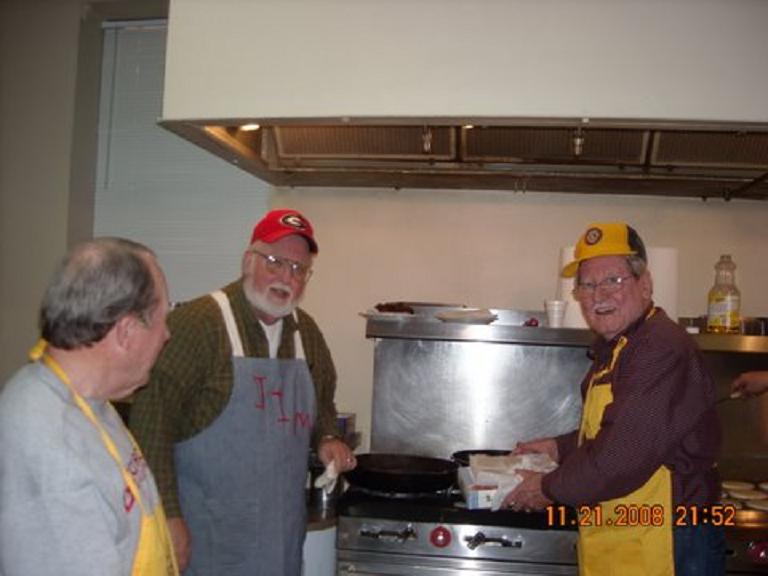 Jim Allison and Wen Williams - cooking sausage